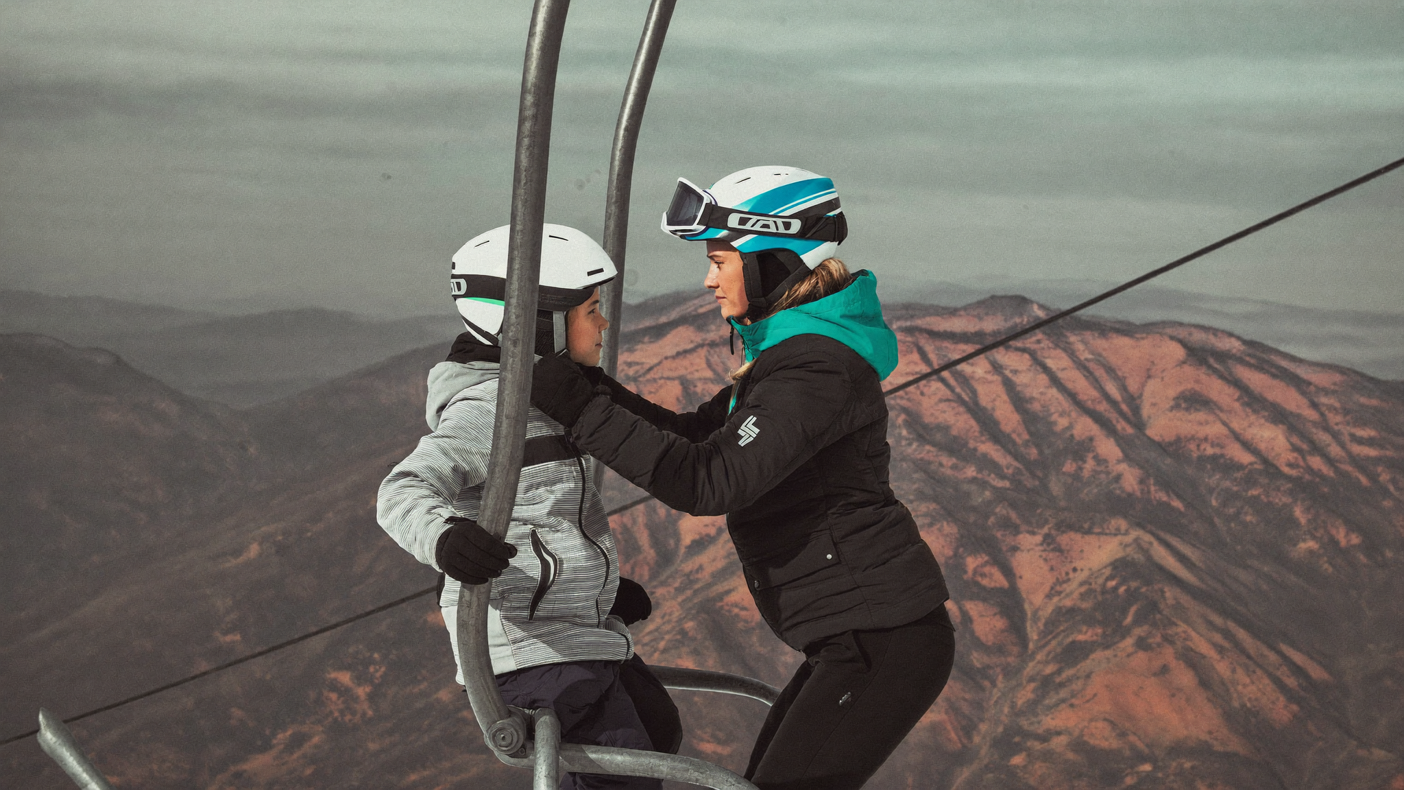 Ski instructor supervising a group of school students at a marked meeting point
